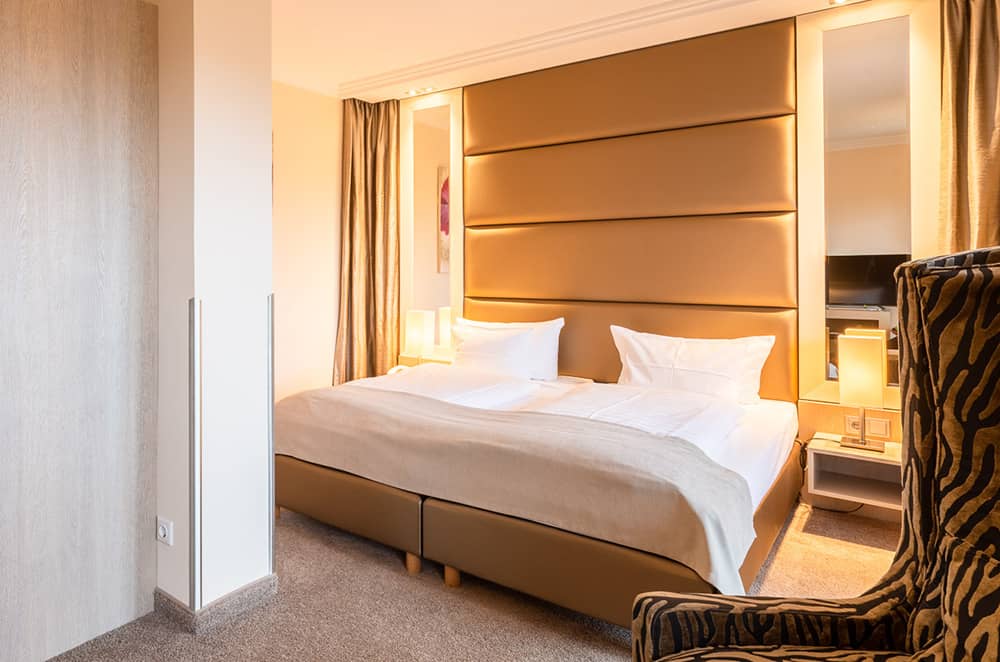 Zimmeransicht mit Bett und stylischem Interieur im For Two Zimmer.